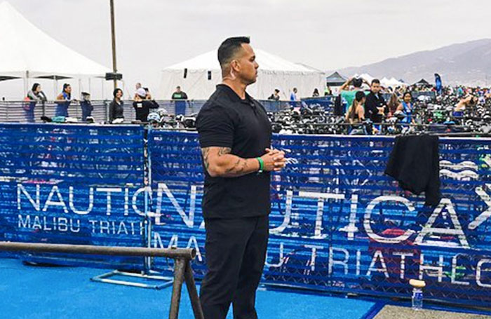 Security guard surveying crowd at red carpet event.